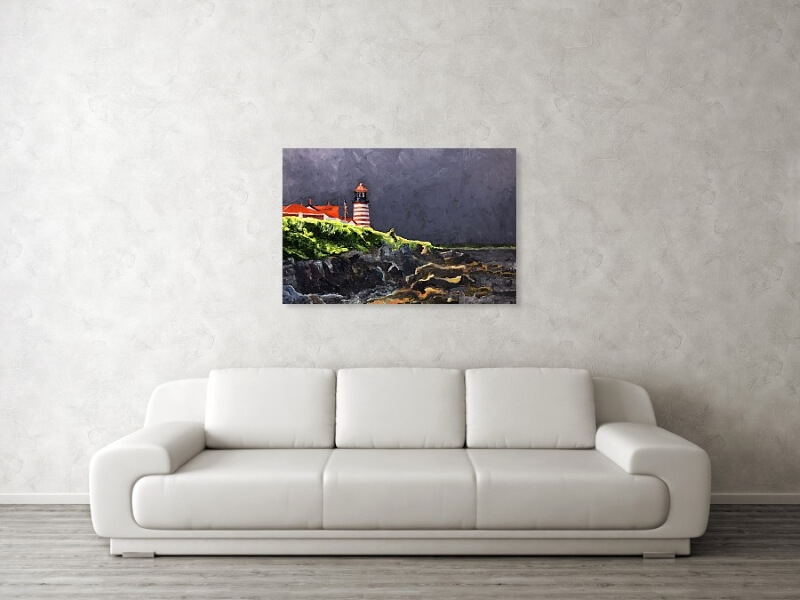 Coastal print of a painting of Maine's West Quoddy Lighthouse hanging above a couch